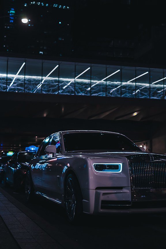 A white Rolls-Royce at night, off the map.